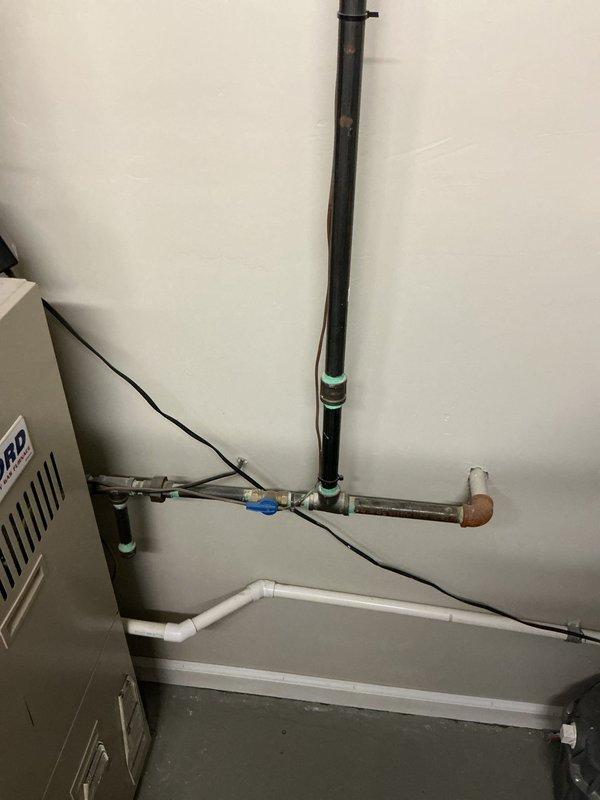 Completed furnace estimate for residential property, evaluating existing HVAC system located in mechanical room with white wall-mounted unit. Assessed installation conditions including existing plumbing infrastructure, electrical connections, and available space for potential equipment replacement or upgrade.
