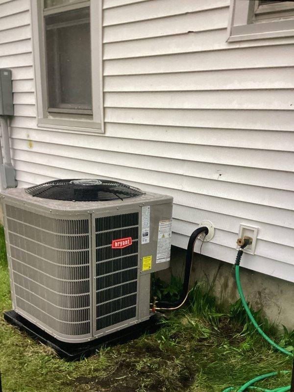 Completed full HVAC system installation including a new 16.5 SEER2 Bryant outdoor condensing unit mounted on pad with corresponding cased evaporator coil integrated with existing Goodman furnace in basement utility area. Additionally installed mini split heat pump system with outdoor condensing unit and indoor head unit. Installed ceiling-mounted bathroom exhaust fan with dedicated electrical circuit, ran venting through attic space, and terminated through soffit for proper exterior discharge.