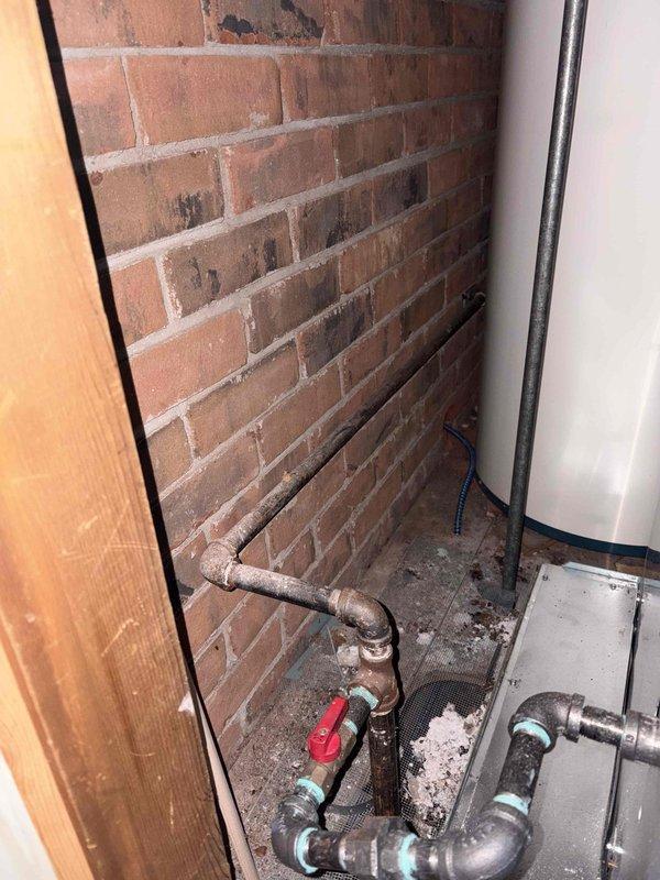 Installed code-compliant sediment trap on gas line serving water heater per 2015 MRC G2419.4 requirements and manufacturer specifications. Correction addressed inspection disapproval PM2025-1053, ensuring proper sediment filtration protection for gas appliance. Documentation photos captured showing completed installation with proper fittings and valve configuration.