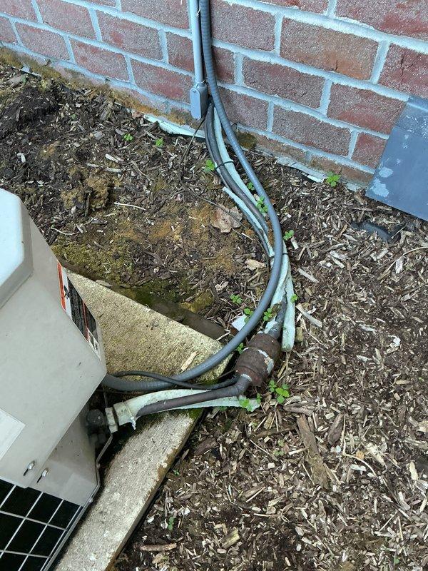 Conducted on-site evaluation of aging air conditioning system requiring obsolete refrigerant type. Assessed existing outdoor condensing unit mounted on concrete pad against exterior brick wall, noting weathered refrigerant lines and electrical conduit routing. Documented current equipment configuration and discussed replacement options with modern, code-compliant system utilizing current-generation refrigerant. Provided comprehensive HVAC replacement estimate for updated equipment installation.