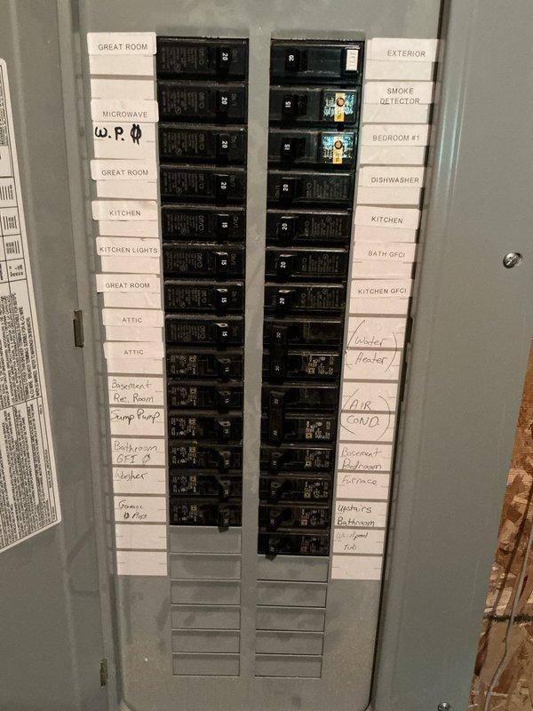 Conducted on-site assessment for standby generator installation. Documented existing electrical panel configuration showing 200-amp service with circuit distribution for residential loads including HVAC, water heater, kitchen appliances, sump pump, and general lighting circuits. Evaluated Marathon electric water heater specifications and overall electrical system capacity to determine generator sizing requirements and transfer switch placement options for whole-house backup power solution.