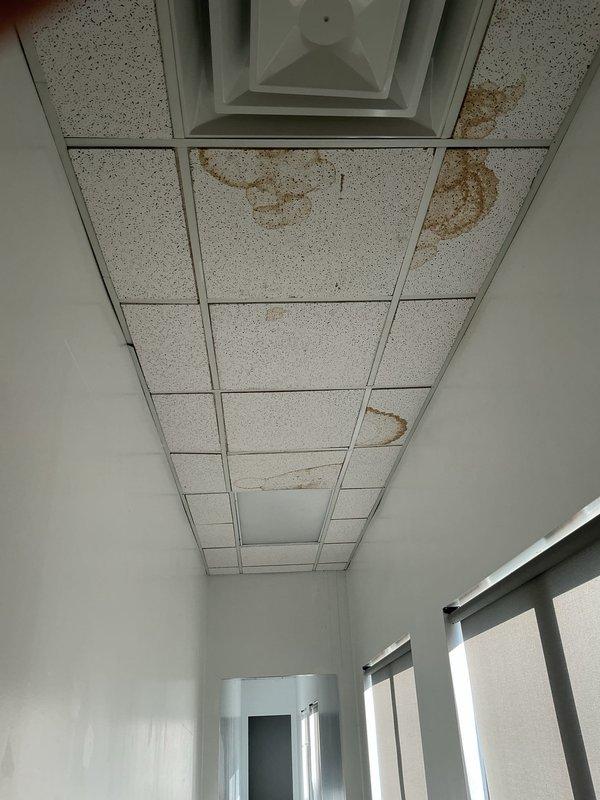 Responded to service call for non-functioning air conditioning system following previous service visit where unit remained inoperative. Conducted comprehensive assessment of both HVAC units to determine root cause of cooling failure. Performed diagnostic evaluation including visual inspection of indoor and outdoor equipment, electrical components, and refrigerant system. Documented existing conditions through photographic evidence showing interior spaces and ceiling-mounted air distribution components. Observed water staining on ceiling tiles near supply diffuser, indicating potential condensate drainage issues or refrigerant leak. Prepared detailed estimate for necessary repairs to restore proper operation of malfunctioning AC system and provided quote for service work on both units as requested.
