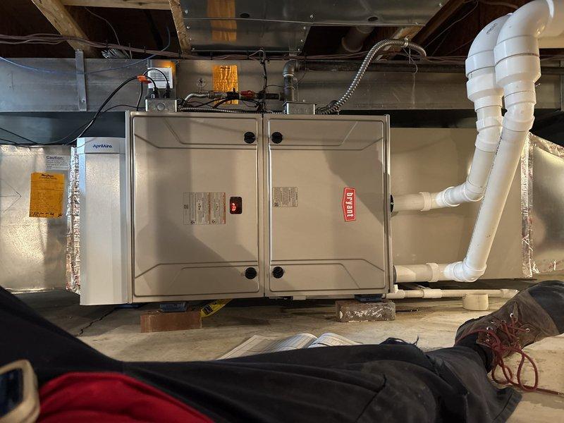 Completed HVAC installation in basement crawl space, including mounting air handler unit with proper electrical connections and conduit routing. Installed flexible ductwork with reflective insulation wrap and sealed all connections with foil tape to prevent air leakage and pest intrusion. Verified outdoor condenser unit connections, condensate drain lines, and electrical service are properly secured and operational.