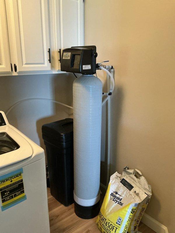 Completed installation of three major plumbing systems at residential property. Installed new 1/2 horsepower sump pump with check valve to prevent water backup. Replaced existing water heater with Bradford White 50-gallon tall conventional vent propane unit, including all necessary connections and venting. Installed Sterling Fest series FEST45 water treatment system combining water softener and tannin removal capabilities in utility room adjacent to laundry area. All systems tested and operational upon completion.
