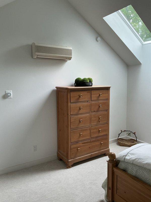 Conducted on-site assessment for installation of five mini-split AC systems in residential property. Evaluated bedroom space with existing wall-mounted unit and under-stair storage area to determine optimal placement, electrical requirements, and installation logistics for new ductless HVAC equipment. Documented existing conditions through photographs to support equipment sizing and installation estimate preparation.
