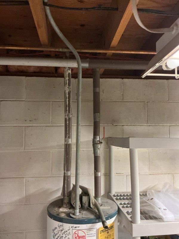Performed on-site estimate for replacement of existing 15-year-old Rheem 50-gallon electric water heater located in basement utility area. Inspected current installation including copper supply piping, pressure tank configuration, and electrical connections to assess replacement requirements. Documented equipment specifications and installation conditions to provide estimate for new AO Smith electric water heater installation with comparable capacity and specifications.