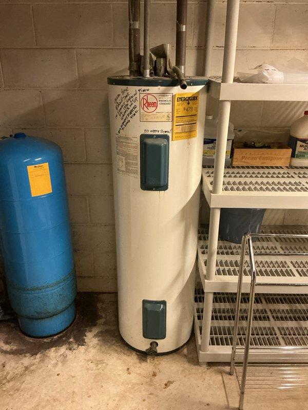 Performed on-site estimate for replacement of existing 15-year-old Rheem 50-gallon electric water heater located in basement utility area. Inspected current installation including copper supply piping, pressure tank configuration, and electrical connections to assess replacement requirements. Documented equipment specifications and installation conditions to provide estimate for new AO Smith electric water heater installation with comparable capacity and specifications.