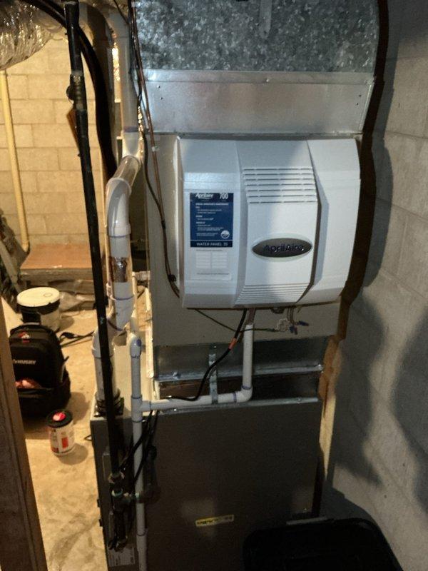 Replaced existing 700M humidifier with new Aprilaire unit in basement mechanical room. Modified water supply lines and adjusted ductwork connections to accommodate updated equipment style and mounting requirements. Verified proper installation, connections, and operation of humidifier system upon completion.