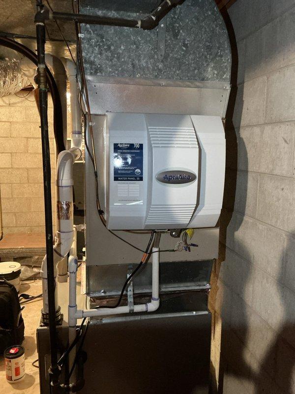 Replaced existing 700M humidifier with new Aprilaire unit in basement mechanical room. Modified water supply lines and adjusted ductwork connections to accommodate updated equipment style and mounting requirements. Verified proper installation, connections, and operation of humidifier system upon completion.