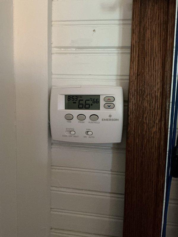 Conducted sales estimate for 40-year-old furnace located in crawlspace that is currently operational but nearing end of service life. Documented existing HVAC system configuration including Emerson programmable thermostat and electrical panel with Wayne's Electric installation, photographed equipment conditions to provide comprehensive replacement options and recommendations for aging heating system.