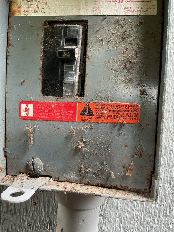 Conducted on-site assessment for AC estimate. Documented existing electrical panel showing significant rust and corrosion throughout metal surfaces, with deteriorated condition indicating potential safety concerns for new equipment installation. Evaluated existing mechanical Honeywell thermostat for compatibility with proposed system upgrades.