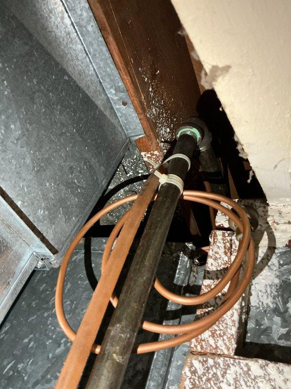 Conducted sales estimate for furnace replacement in residential property. Documented existing HVAC system components including GE SmartWater PowerVent water heater (Model GPM10T67LH1, manufactured 06/2007) with 40,000 BTU input capacity rated for liquid petroleum fuel, along with associated ductwork, copper plumbing lines, and mechanical room infrastructure showing age-related wear and accumulated debris. Photographed equipment specifications and utility space conditions to provide comprehensive assessment for heating system upgrade proposal.
