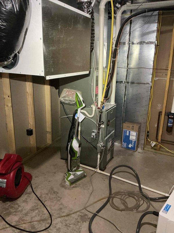 Responded to emergency water leak call involving recently installed humidifier that caused basement damage. Arrived on-site to document and investigate the leak source after remediation company had already addressed water damage. Conducted thorough inspection of HVAC system and humidifier installation, photographed affected areas including basement carpet damage and furnace/humidifier assembly. Documented findings showing cleaning equipment present from remediation work, inspected humidifier connections, water supply lines, and drainage system to identify failure point. Completed photographic documentation of damage extent and equipment condition for further review and determination of root cause.