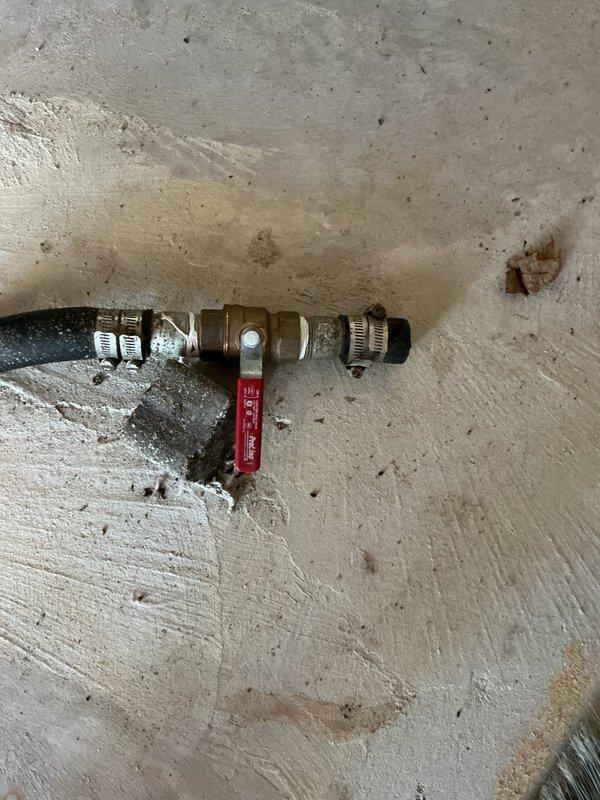 Extended existing water supply line from floor level in unheated pole barn and installed new outdoor spigot with shutoff valve. Applied heat tape to exposed piping to prevent freezing during cold weather months.