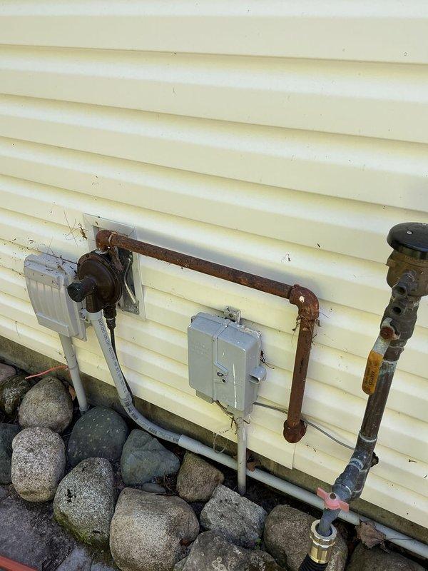 Conducted on-site assessment for new residential generator installation at property with no existing backup power system. Evaluated existing electrical panel containing Square D breakers and documented exterior utility infrastructure including gas lines, electrical service connections, and available mounting locations on exterior wall with vinyl siding. Coordinated appointment timing to accommodate customer schedule and captured photographic documentation of electrical panel configuration and proposed generator placement area near existing utility connections.