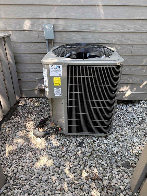 Completed full installation of Bryant furnace system, Puron Advance air conditioning unit, and water heater at residential property. Interior furnace installed in utility closet with proper ventilation ductwork including 90-degree elbow configuration, exterior AC unit positioned on gravel pad with electrical disconnect mounted to exterior wall, and water heater installed with copper piping connections. All equipment properly labeled, vented, and tested for operation with standard residential HVAC installation practices followed throughout.