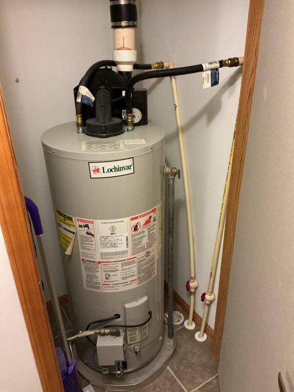 Performed estimate for installing a hot water booster system to provide adequate hot water supply for a Jacuzzi tub. Inspected existing 20-year-old Lochinvar water heater, which is currently functioning without issues, and documented installation conditions including plumbing connections, pressure relief valve assembly, and utility room configuration to determine booster system requirements and compatibility.