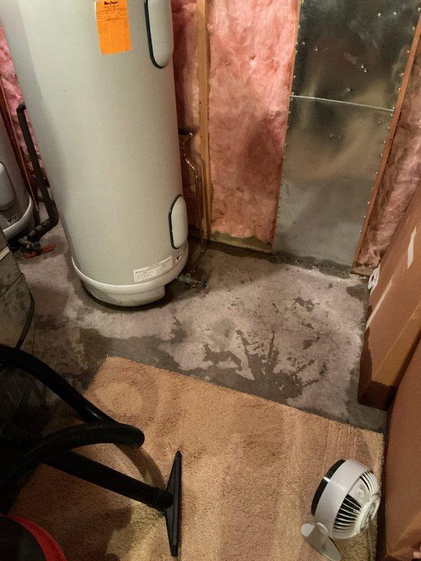 Responded to water heater leak originating from top connections causing water damage to basement floor. Upon inspection, identified compromised pipe fittings and connections above dual Marathon water heater installation. Assessed plumbing configuration including copper, PVC, and metal piping network with multiple junction points and shut-off valves. Documented moisture damage on concrete floor and evaluated overall system integrity to determine source of active leak and recommend appropriate repairs.