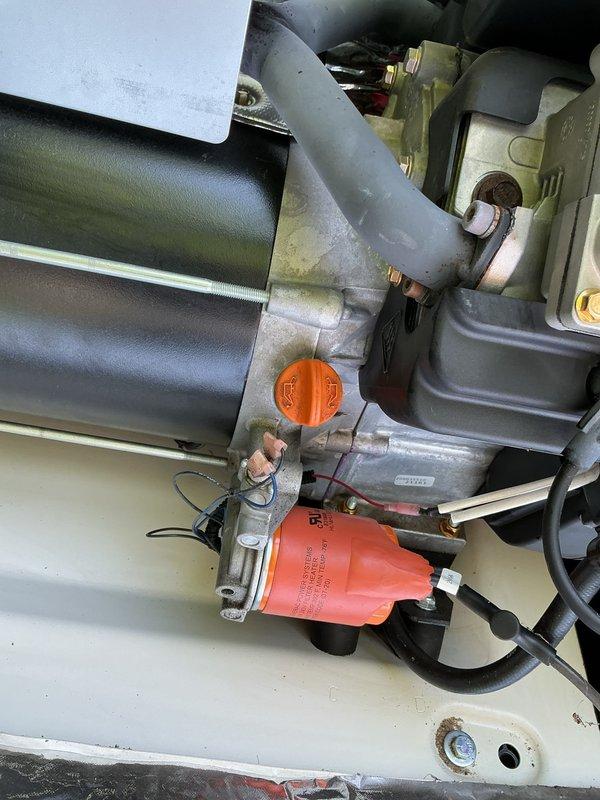 Completed scheduled preventive maintenance tune-up on Generac standby generator unit. Performed comprehensive inspection of engine components, verified proper operation of cooling fan assembly, checked all fluid levels and replaced engine oil and filter. Inspected fuel system components including fuel filter and lines for proper condition and secure connections. Verified all electrical connections, battery condition, and control system functionality. Cleaned unit interior, checked mounting hardware for tightness, and documented system condition with photos showing engine assembly, cooling system, and internal component layout.