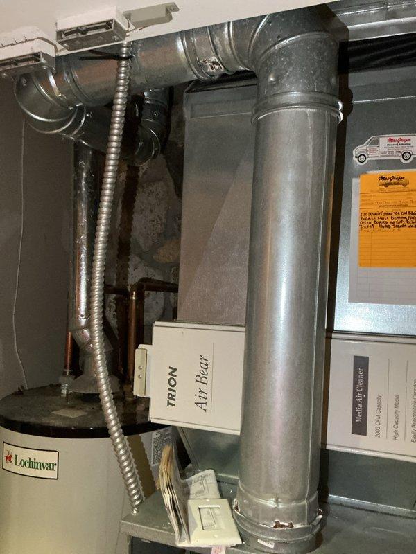 Conducted comprehensive estimate for complete furnace and air conditioning system replacement. Evaluated existing HVAC installation including current air handler unit, ductwork configuration with TRION Air Bear filtration system, and mechanical room layout. Assessed vertical main supply trunk, flexible duct connections, and overall system accessibility for replacement equipment. Documented existing plumbing infrastructure, water heater proximity, and utility room constraints to determine optimal equipment placement and installation requirements. Photographed current equipment specifications, duct configuration, and mechanical space conditions to provide accurate proposal for new high-efficiency heating and cooling system installation.