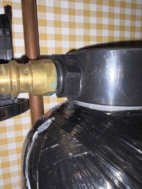 Responded to water heater moisture alarm issue on MAC-installed unit. Upon inspection, found high humidity levels in installation area which was triggering the alarm sensor. Examined plumbing connections and water heater components, documenting brass fittings, copper piping, and flexible supply lines for proper installation and potential leak sources. Determined alarm activation was environmental rather than equipment failure, with no active leaks detected at connection points or heater base.