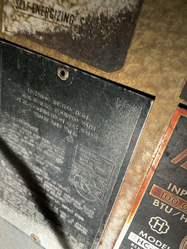 Conducted sales estimate for boiler replacement in residential property. Documented existing aged heating equipment showing significant wear, deterioration, and accumulated debris on metal surfaces and components with visible BTU rating plates. Assessed ductwork system including ceiling-mounted flexible metallic ducting with mounting flanges and evaluated overall HVAC infrastructure condition to provide comprehensive replacement recommendations.