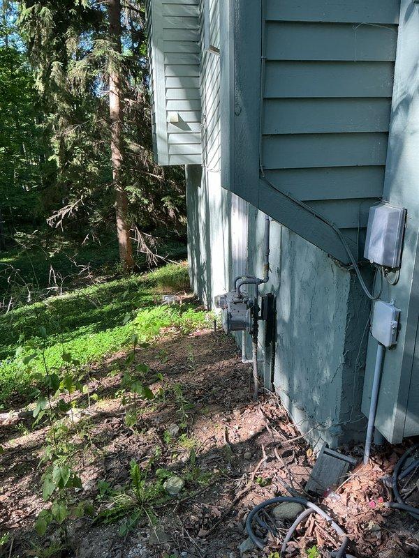 Conducted on-site evaluation for central air conditioning installation estimate for a 1700 square foot residential property. Assessed existing home infrastructure including exterior utility connections, electrical service panel location, and basement mechanical space with current ductwork and plumbing configuration to determine optimal placement and installation requirements for new HVAC system.