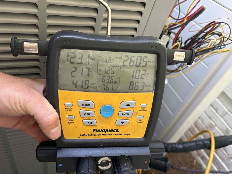 Responded to no cooling complaint on Armstrong air conditioning system. Upon arrival, connected refrigerant manifold gauges to service ports and performed diagnostic testing. System readings indicated abnormal operating pressures and temperatures, confirming inadequate cooling performance. 

Conducted comprehensive system evaluation including pressure testing, temperature differential measurements, and visual inspection of all accessible components. Identified issues affecting system performance and cooling capacity. Performed complete tune-up service as requested by customer, which included inspection of evaporator coil assembly, blower components, and refrigeration circuit connections.

Documented system operating conditions with diagnostic gauge readings showing suction and discharge pressures, superheat, subcooling, and saturation temperatures. Inspected refrigerant line connections and service valve assemblies for proper operation. Addressed cooling deficiency and restored system 