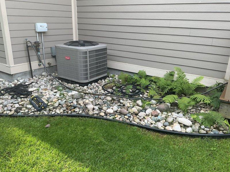 Conducted on-site evaluation for standby generator installation at residential property. Documented existing electrical infrastructure including HVAC condensing unit and electrical disconnect box, photographed current utility equipment including water heater specifications, and assessed outdoor installation area with landscaping considerations for proper generator placement and clearances.