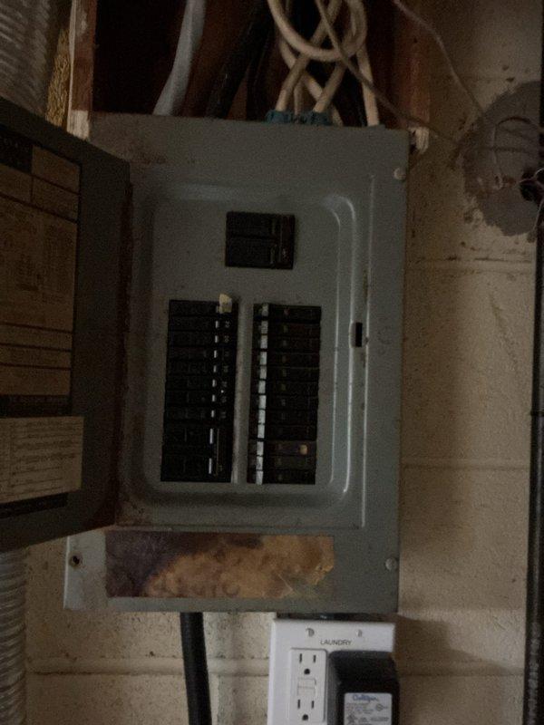 Conducted site assessment for standby generator installation at residential property. Evaluated existing electrical panel configuration in basement utility area, documenting current breaker layout and main service capacity to determine generator transfer switch requirements and proper integration with home electrical system.