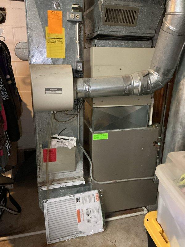 Conducted comprehensive AC estimate for residential property. Documented existing HVAC system including furnace unit with connected Honeywell humidifier and ductwork configuration in basement utility area, and photographed exterior access points including deck stairway to assess installation requirements and system accessibility for potential air conditioning equipment upgrade.