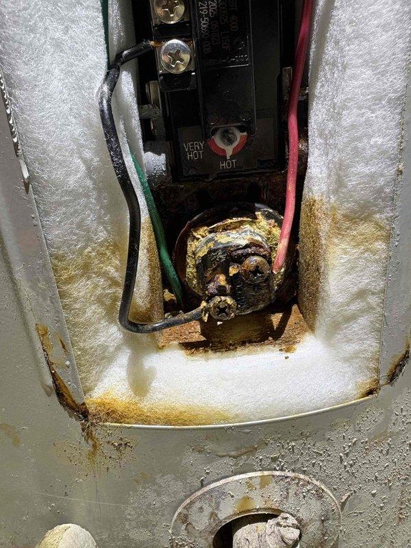 Responded to service call for reduced hot water production following recent flooding event. Upon inspection of 5-year-old water heater located in crawlspace, discovered severe internal corrosion and deterioration of heating elements and chamber components. Evidence of significant water intrusion and moisture damage was present throughout the unit, with extensive rust buildup, scaling, and discoloration on heating elements and internal surfaces. The flooding had compromised the water heater's ability to function properly, causing the reported decrease in hot water availability. Documented conditions with photographs showing corroded heating element assembly and damaged internal components. Advised that unit sustained substantial flood damage requiring replacement due to safety concerns and extent of corrosion. Explained that continued operation poses risk of failure and potential safety hazards. Provided recommendations for replacement options and discussed proper installation considera
