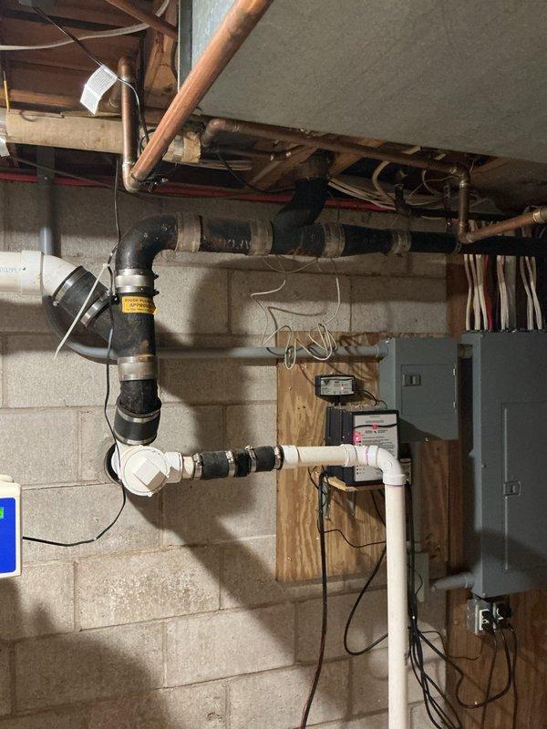 Responded to guest bathroom toilet not flushing properly for several weeks. Assessed plumbing system and drainage lines in basement utility area. Inspected main drain line connections, vent stack configuration, and associated plumbing infrastructure to identify blockage source beyond reach of standard plunging methods, successfully restoring proper toilet function.
