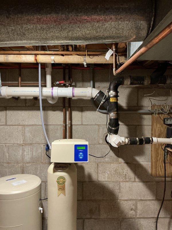 Responded to guest bathroom toilet not flushing properly for several weeks. Assessed plumbing system and drainage lines in basement utility area. Inspected main drain line connections, vent stack configuration, and associated plumbing infrastructure to identify blockage source beyond reach of standard plunging methods, successfully restoring proper toilet function.