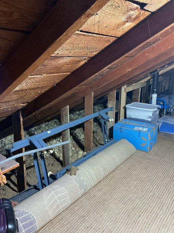 Conducted site assessment for new high velocity HVAC system installation in older home without existing high velocity equipment. Inspected attic space to evaluate structural conditions, available routing pathways, and installation feasibility for compact ductwork and air handler placement. Documented existing attic configuration including storage layout, framing structure, access points, and observed what appears to be current HVAC components including flexible ductwork and mechanical equipment mounted on support framework. Photographed attic conditions to support system design and provide accurate quote for complete high velocity system installation.