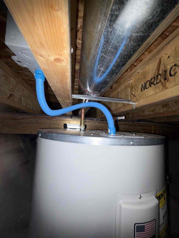 Installed replacement low boy water heater in crawl space. Unit was ordered from Ferguson, received, and staged in shop prior to installation. Completed water heater replacement including all necessary plumbing connections with PEX supply lines and proper venting. Installation performed in unfinished basement area with exposed floor joists, ensuring proper clearances and code compliance for the residential water heating system.