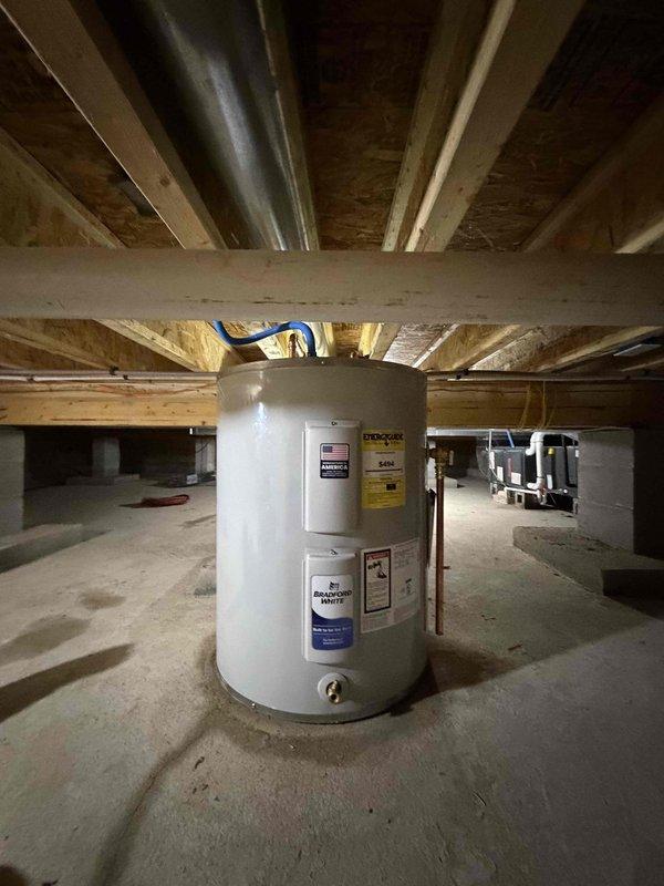 Installed replacement low boy water heater in crawl space. Unit was ordered from Ferguson, received, and staged in shop prior to installation. Completed water heater replacement including all necessary plumbing connections with PEX supply lines and proper venting. Installation performed in unfinished basement area with exposed floor joists, ensuring proper clearances and code compliance for the residential water heating system.
