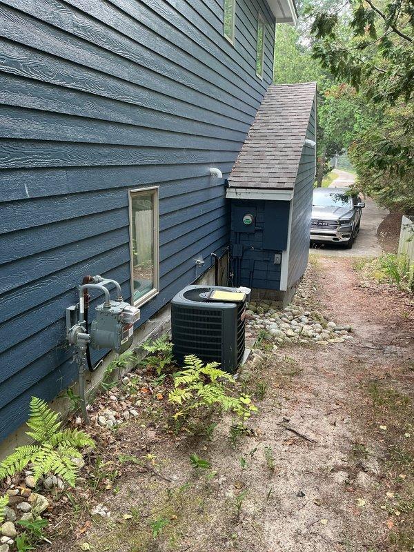 Conducted site assessment for whole home standby generator installation. Evaluated existing electrical service infrastructure, documenting 200-amp main service panel with Stratus IQ digital meter and current electrical capacity. Photographed meter base configuration, service entrance location, and available installation area adjacent to existing HVAC equipment on exterior foundation. Assessed clearance requirements, utility access points, and optimal generator placement on concrete pad near house perimeter. Reviewed electrical load requirements and transfer switch integration options with existing 240V three-wire service. Prepared comprehensive estimate for complete standby generator system installation including equipment specifications, transfer switch, and necessary electrical connections.