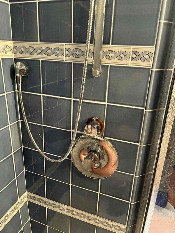 Responded to service call for multiple plumbing issues including master bathroom lacking hot water, disconnected refrigerator water line, and washing machine water supply problem. Inspected shower fixtures and valve assembly in master bathroom, documented existing conditions and mineral buildup on fixtures. Addressed water supply concerns and restored proper water flow to affected areas.