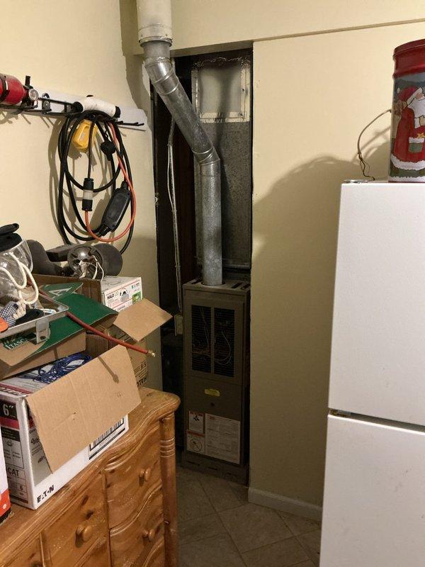 Conducted on-site assessment of existing HVAC system for air conditioning estimate. Evaluated current thermostat functionality, inspected furnace unit and ductwork configuration in utility area, documented equipment condition and spatial constraints, and photographed existing installation to develop comprehensive replacement or upgrade proposal.