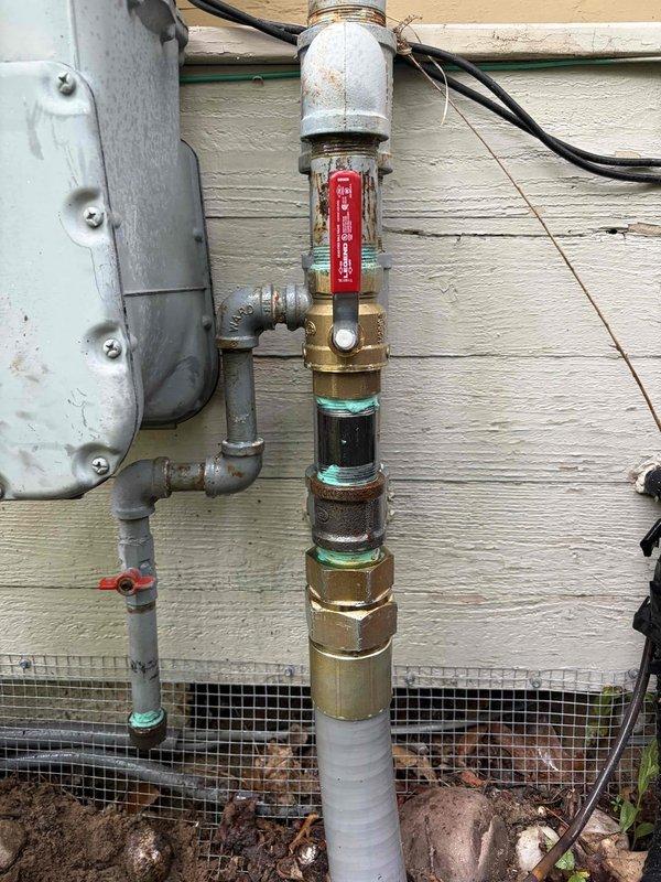Responded to quoted repair for underground gas piping correction. Upon arrival, found existing gas riser installation with non-compliant underground piping requiring correction per safety and mechanical code standards. Removed and replaced underground gas piping sections with proper materials and fittings. Installed new brass shutoff valve with red handle on vertical riser assembly. Connected galvanized pipe sections above grade and ensured proper transition to underground piping with code-compliant materials. Verified all connections for proper fitment and gas-tight seals. Backfilled excavation area around pipe penetration and installed protective mesh barrier at grade level. Tested system for leaks and confirmed all connections meet safety standards. Left installation secure and operational with proper access to shutoff valve.