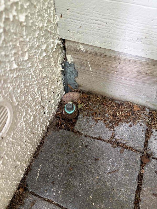 Responded to quoted repair for underground gas piping correction. Upon arrival, found existing gas riser installation with non-compliant underground piping requiring correction per safety and mechanical code standards. Removed and replaced underground gas piping sections with proper materials and fittings. Installed new brass shutoff valve with red handle on vertical riser assembly. Connected galvanized pipe sections above grade and ensured proper transition to underground piping with code-compliant materials. Verified all connections for proper fitment and gas-tight seals. Backfilled excavation area around pipe penetration and installed protective mesh barrier at grade level. Tested system for leaks and confirmed all connections meet safety standards. Left installation secure and operational with proper access to shutoff valve.