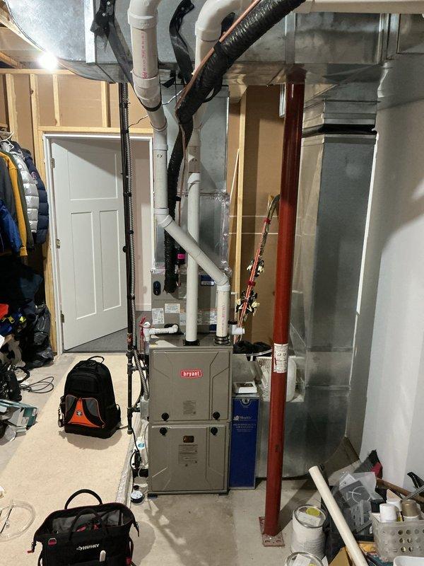 Installed new condensate pump with discharge line routed to P-trap for Bryant furnace system. Secured all PVC piping and electrical connections, verified proper pump operation and drainage flow.