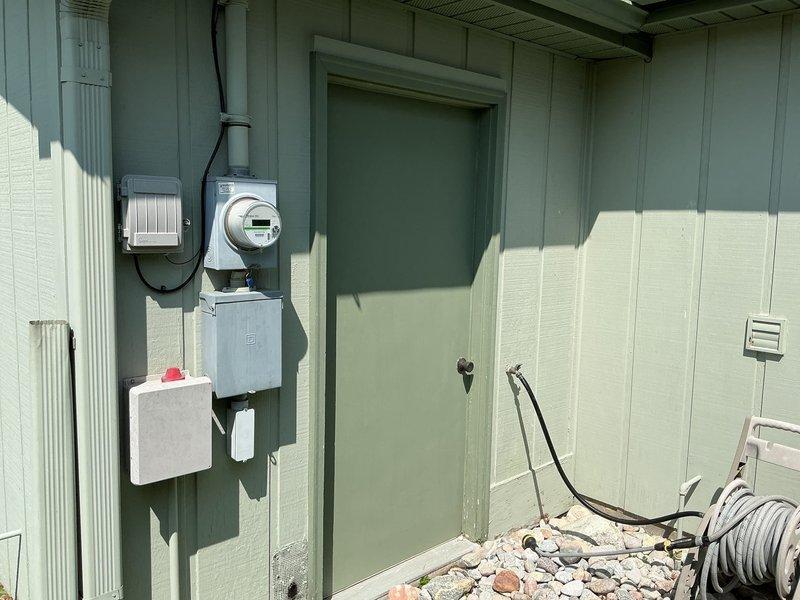 Conducted on-site evaluation for whole-house generator installation at property with no existing backup power system. Assessed existing electrical infrastructure including main service panel, meter, and disconnect locations on exterior wall. Documented current electrical panel configuration and circuit directory to determine generator sizing requirements and integration points for automatic transfer switch installation. Evaluated optimal generator placement considering proximity to existing electrical service, natural gas or LP fuel source access, and clearance requirements per manufacturer specifications for Generac equipment.