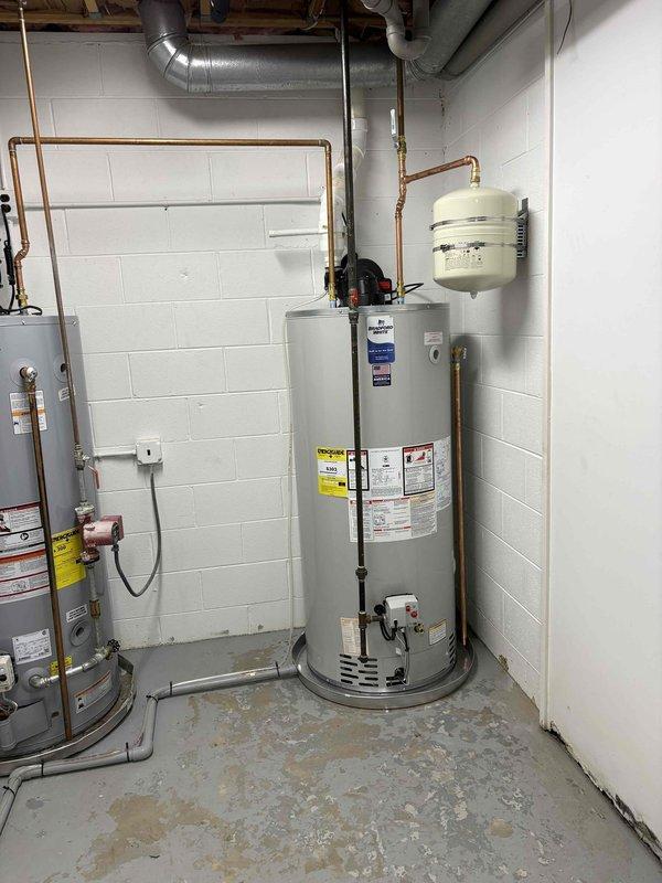 Installed a 75-gallon power vent water heater with domestic expansion tank in basement utility room. Completed all necessary copper piping connections, venting through existing ductwork system, and integrated thermal expansion tank to protect plumbing system from pressure fluctuations. Unit was staged and prepared prior to installation, with all connections tested and verified operational upon completion.