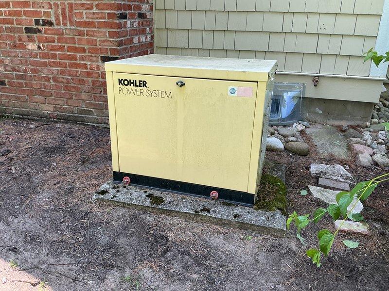 Responded to service call for non-functional Kohler generator system, approximately 23 years old, installed on exterior concrete pad. Upon arrival, coordinated with on-site contact as property owner was unavailable. Conducted visual inspection and documentation of generator unit and associated utility connections, including natural gas meter, supply piping, and electrical components. Generator exhibited signs of age-appropriate wear on housing and mounting surface. Photographed equipment positioning, gas service infrastructure, and surrounding installation area for assessment purposes.