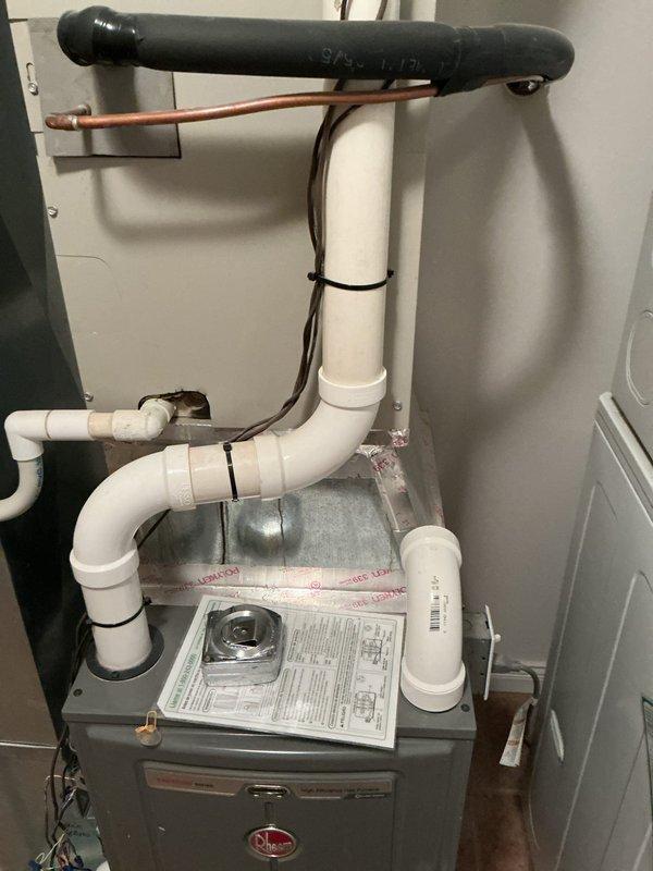 Conducted on-site evaluation of existing HVAC system for air conditioning replacement estimate. Documented current installation including Rheem furnace unit, refrigerant lines, PVC condensate drain and venting configuration, and electrical connections. Photographed equipment layout, piping arrangements, wire terminations with multiple junction points, and mechanical room constraints to provide comprehensive assessment for complete AC system replacement proposal.