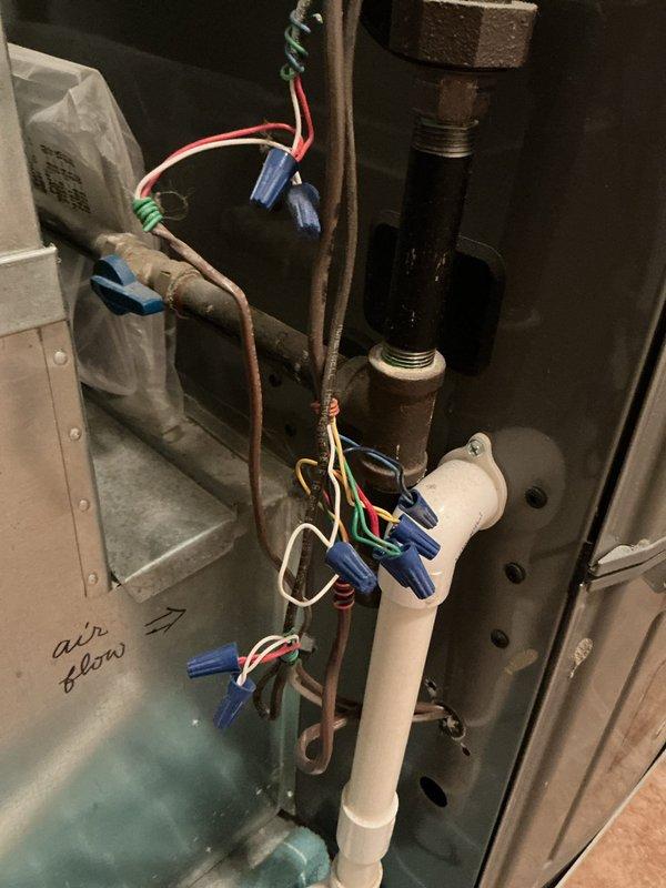 Conducted on-site evaluation of existing HVAC system for air conditioning replacement estimate. Documented current installation including Rheem furnace unit, refrigerant lines, PVC condensate drain and venting configuration, and electrical connections. Photographed equipment layout, piping arrangements, wire terminations with multiple junction points, and mechanical room constraints to provide comprehensive assessment for complete AC system replacement proposal.
