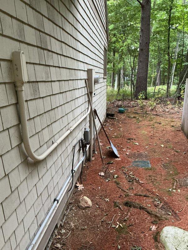 Completed on-site estimate for mini split AC system installation. Evaluated existing exterior HVAC infrastructure including mounted PVC piping and utility connections on cedar shake siding, and assessed current thermostat control system to determine equipment specifications and installation requirements for proposed ductless mini split solution.