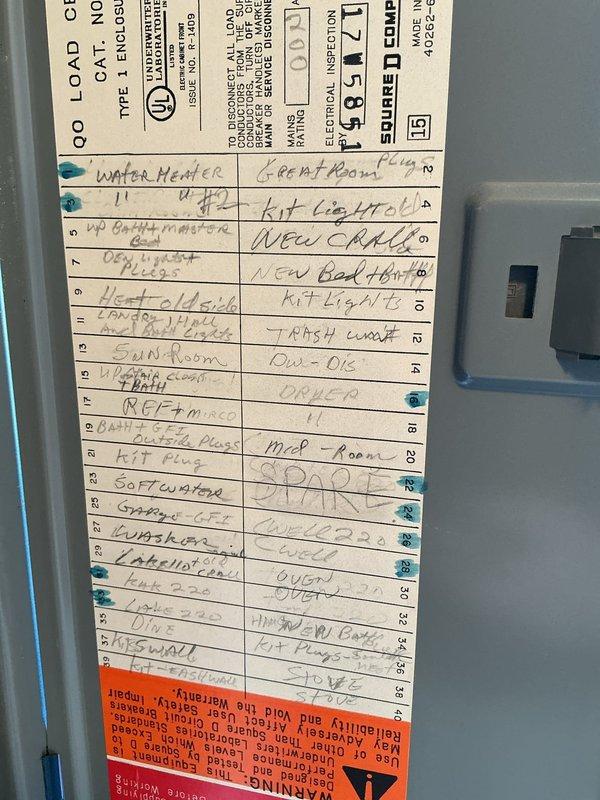 Conducted site evaluation for standby generator installation at residential property. Assessed existing electrical infrastructure by documenting main service panel configuration, including 200-amp main breaker and current circuit distribution. Photographed electrical panel interior showing circuit directory with multiple branch circuits serving water heater, HVAC systems, kitchen appliances, range, dishwasher, garbage disposal, receptacles throughout various rooms, and other household loads. Evaluated panel condition, noting age-related wear and existing load distribution to determine capacity for generator integration. Documented all necessary information to prepare comprehensive estimate for whole-house standby generator system with automatic transfer switch installation.